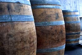 Oak barrels for aging wine are lined up outside